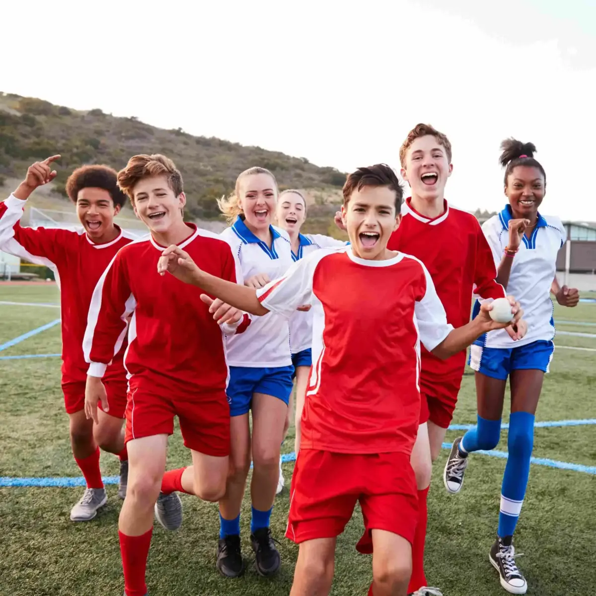 High school soccer players celebrating together